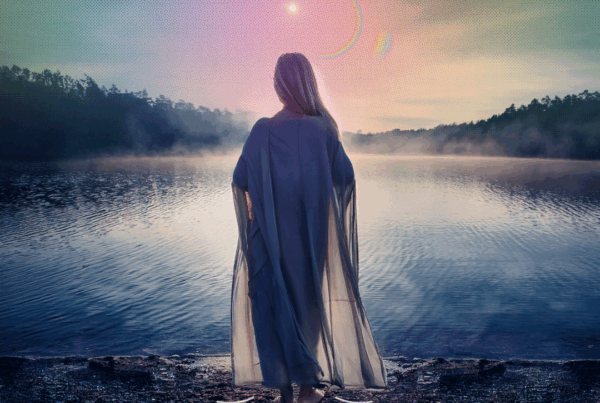 Woman gazing at dawn on the edge of a lake