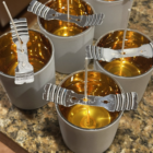 ITBC™ branded hand poured soy wax 8.5 ounce jar candles in the making with long wicks, wick holders, and liquid wax cooling.