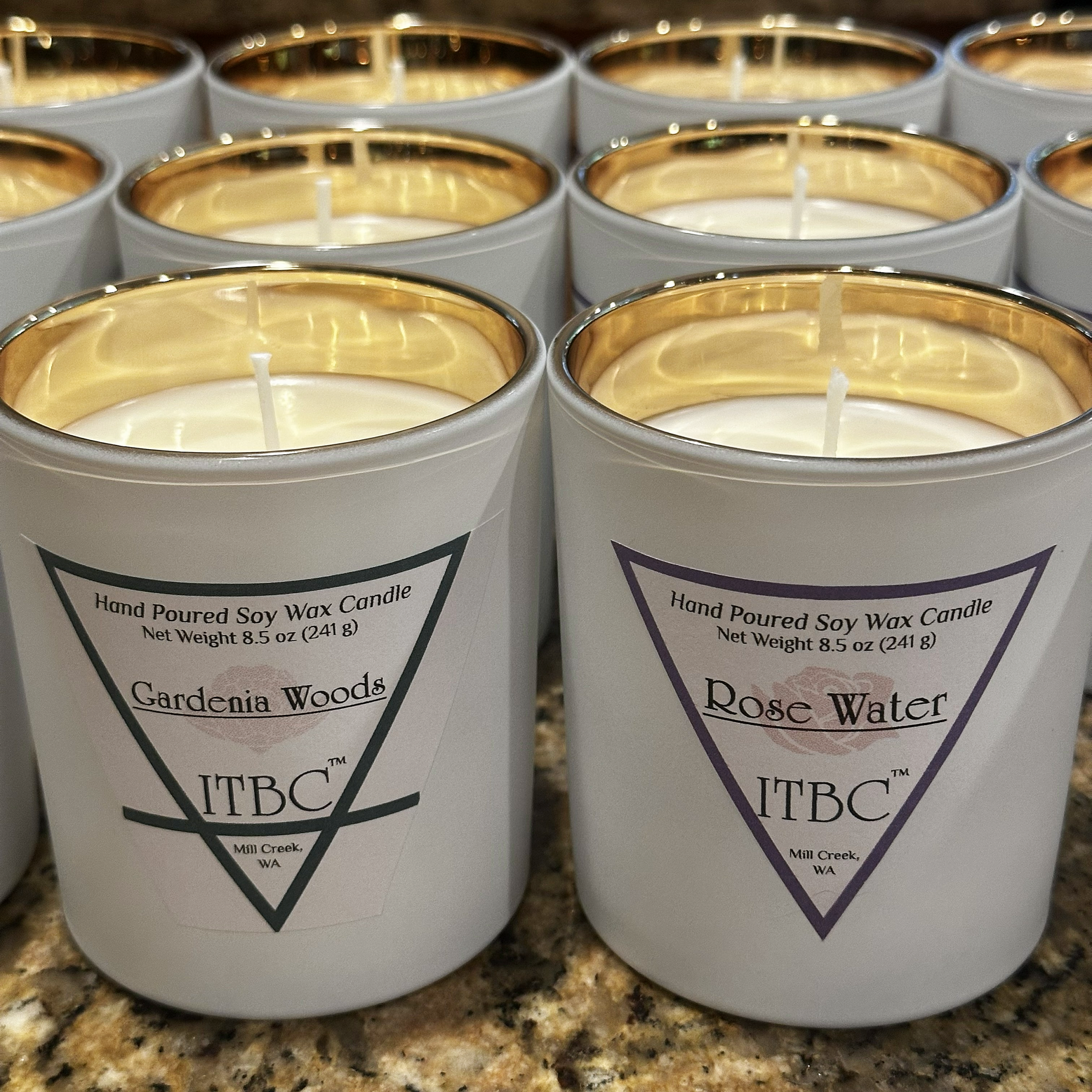 8.5 ounce hand poured soy wax cotton wick jar candles in (Earth) Gardenia Woods and (Water) Rose Water scents hand-made by ITBC™ in Mill Creek, WA. The jars are white glass outside with gold inside
